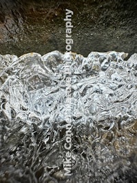 a close up image of ice in a river